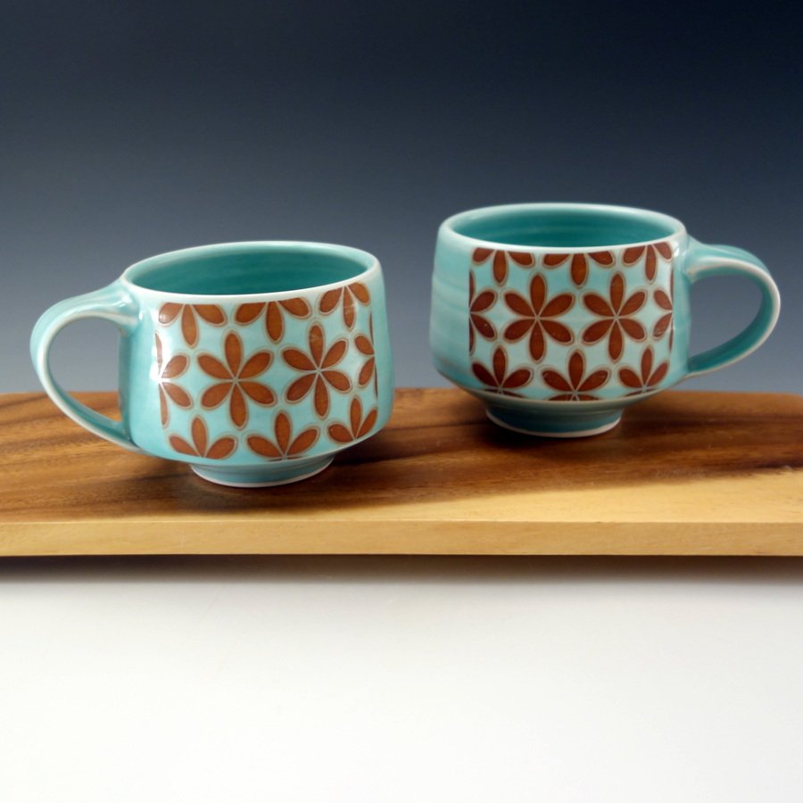 Aquamarine glazed porcelain mugs with floral pattern 